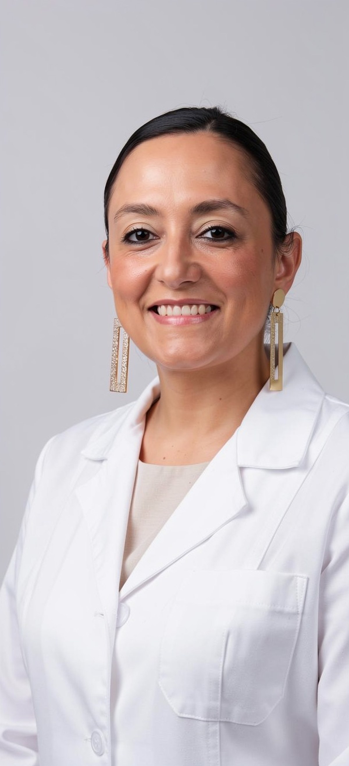Studio portrait of Marcela Riaño Caro in a white laboratory coat against a neutral background.